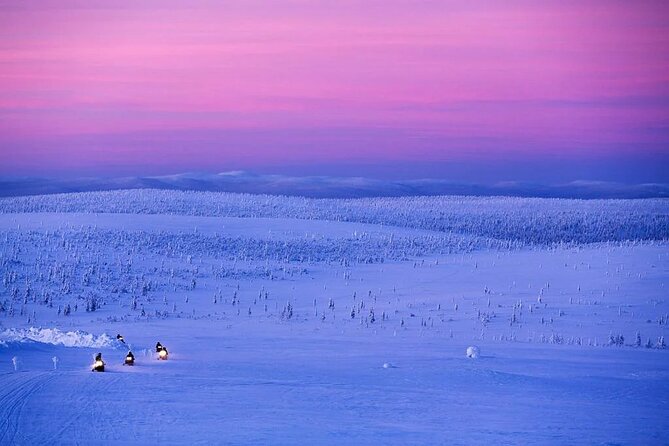 Snowmobile and Ice Fishing Experience - Ice fishing on a frozen lake: drilling first, then learning the Arctic fish story